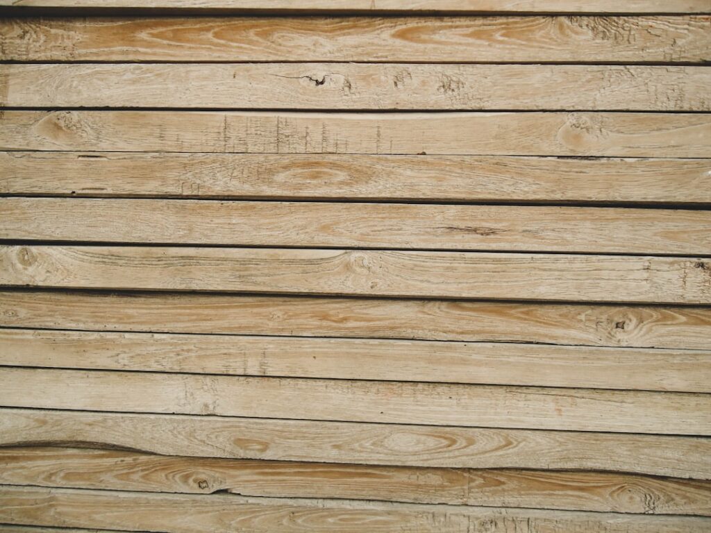 A stack of dimensional 2 by 4 lumber at a construction site ready for framing