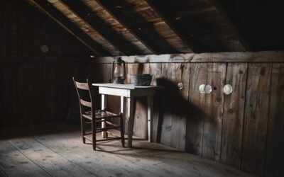 Finished attic space with plywood flooring and exposed roof beams