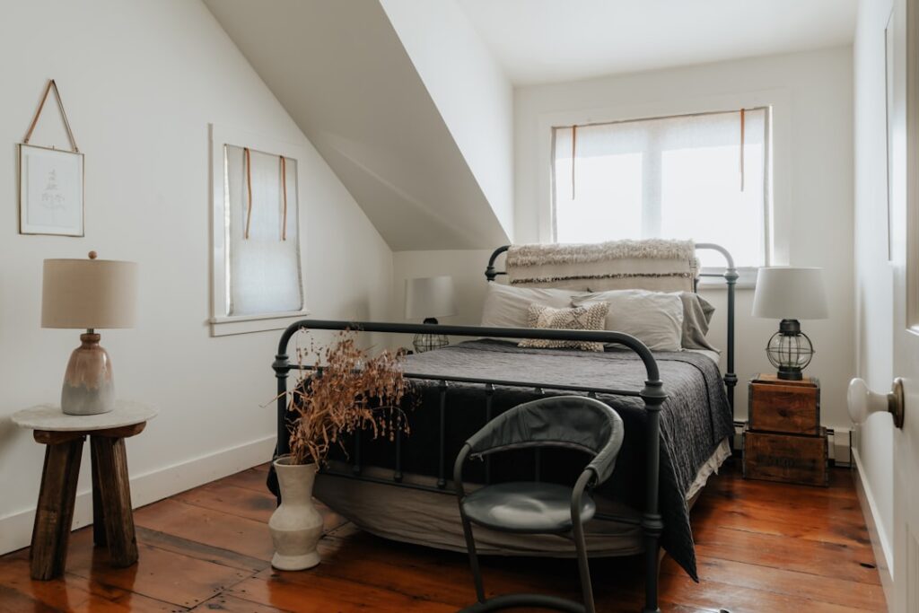 Cozy master bedroom with light oak hardwood flooring and a plush area rug
