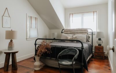 Cozy master bedroom with light oak hardwood flooring and a plush area rug