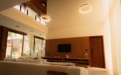 Modern matte black ceiling fan with integrated LED light in a bright living room with hardwood floors