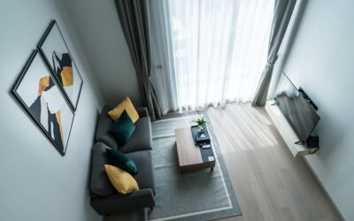 Stylish gray sectional couch on light hardwood flooring in a modern living room