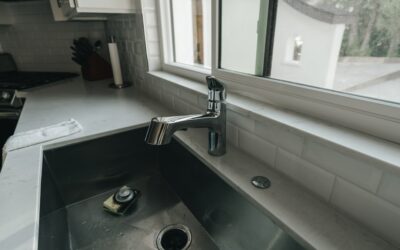 Under sink water filtration system installed beneath a modern kitchen cabinet