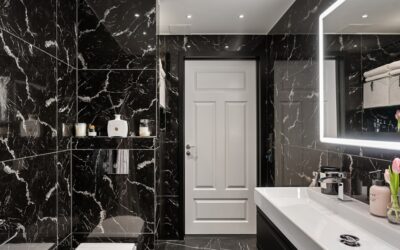 Elegant black and white bathroom with hexagonal floor tile, white subway walls, and matte black fixtures