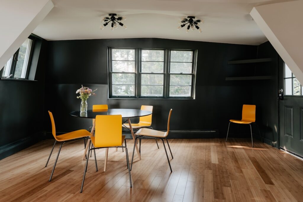 Black oak-look laminate flooring in a modern living room with white walls and minimalist furniture