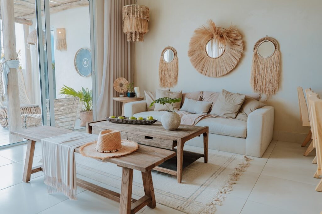 A cozy boho living room with layered rugs, macrame wall hangings, and lush plants