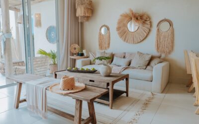 A cozy boho living room with layered rugs, macrame wall hangings, and lush plants