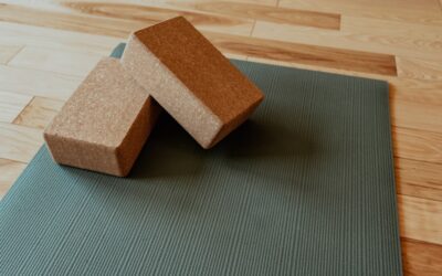 Professional installer using a power stretcher during carpet flooring installation in a bedroom