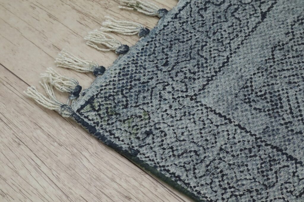 Carpet padding rolls being installed on a subfloor before carpet laying