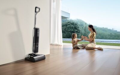 Person mopping a clean hardwood floor with a bucket and cleaning solution nearby
