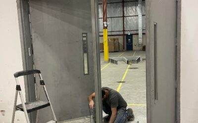 Professional flooring installer measuring and cutting hardwood planks on site