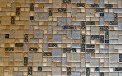 Assorted flooring material samples including hardwood, tile, and stone arranged side by side