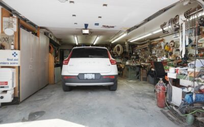 Roll-out garage floor mat protecting concrete underneath a parked vehicle