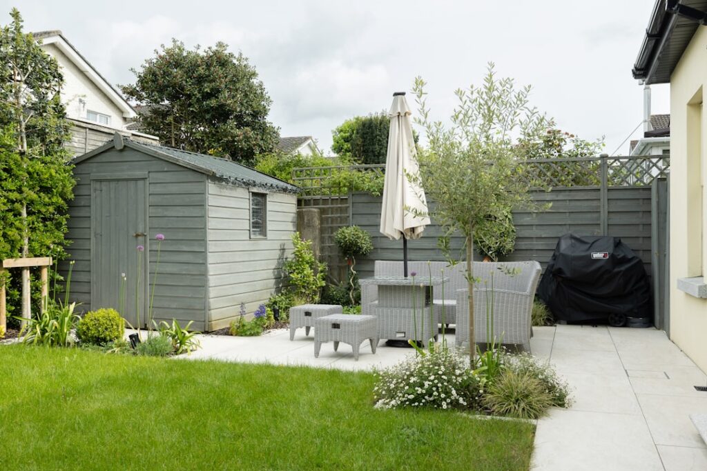 Beautiful garden flooring with stone pavers surrounded by green plants and outdoor furniture