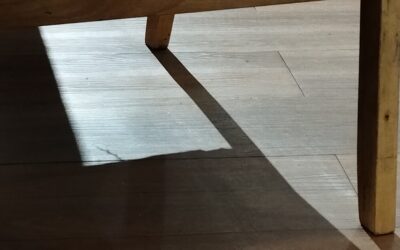 Gray vinyl flooring with a wood-look finish in a modern open-plan living space