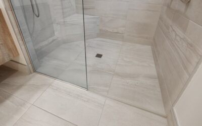 Using a grout saw to remove old grout between ceramic tiles