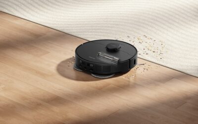 Person using a floor cleaning machine on light hardwood flooring in a bright room