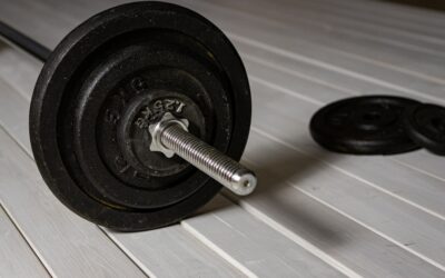 Well-equipped home gym with black rubber flooring, weights, and exercise equipment