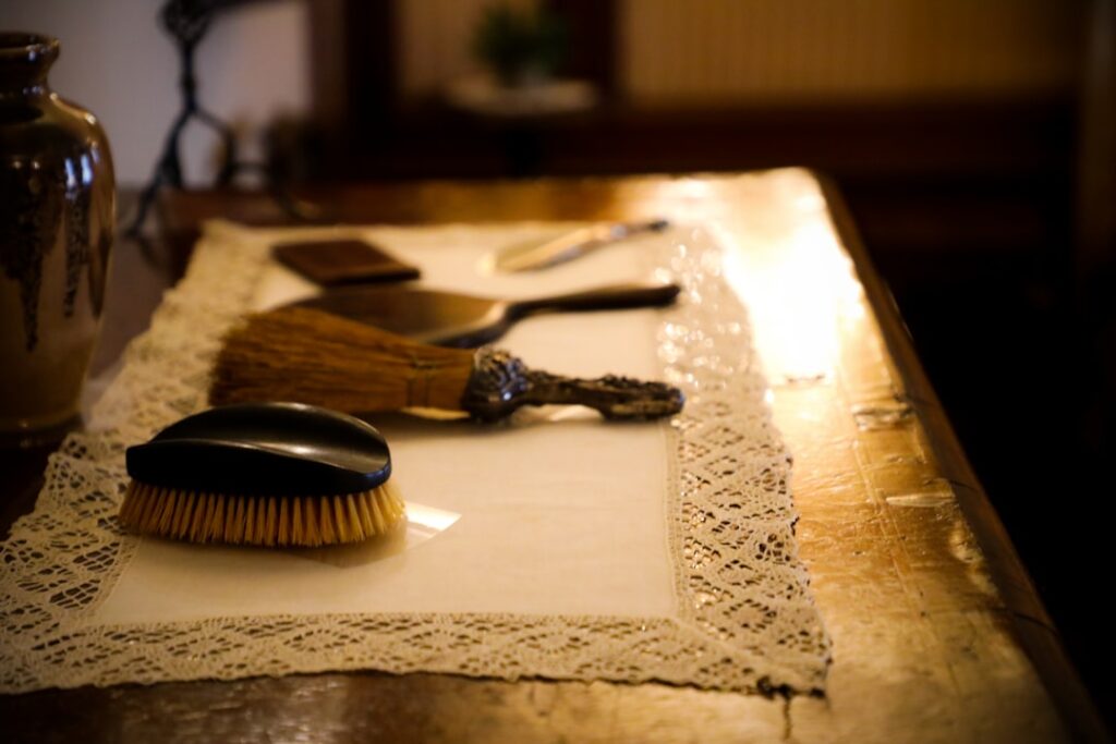 Person cleaning carpet by hand with a scrub brush and cleaning solution