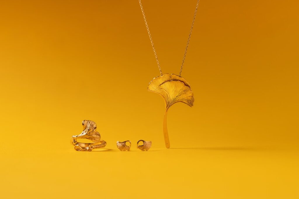 Assorted gold and silver earrings laid out on a soft cloth ready for cleaning