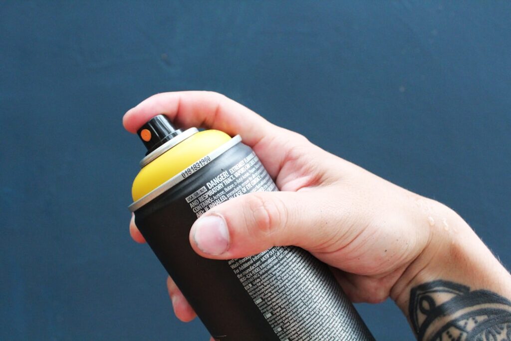 Cleaning supplies and spray bottle next to a carpet for stain removal
