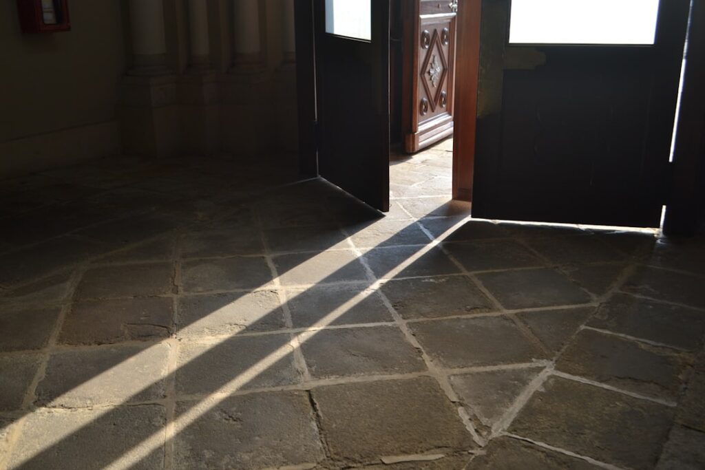 Person installing click-lock laminate flooring planks in a living room
