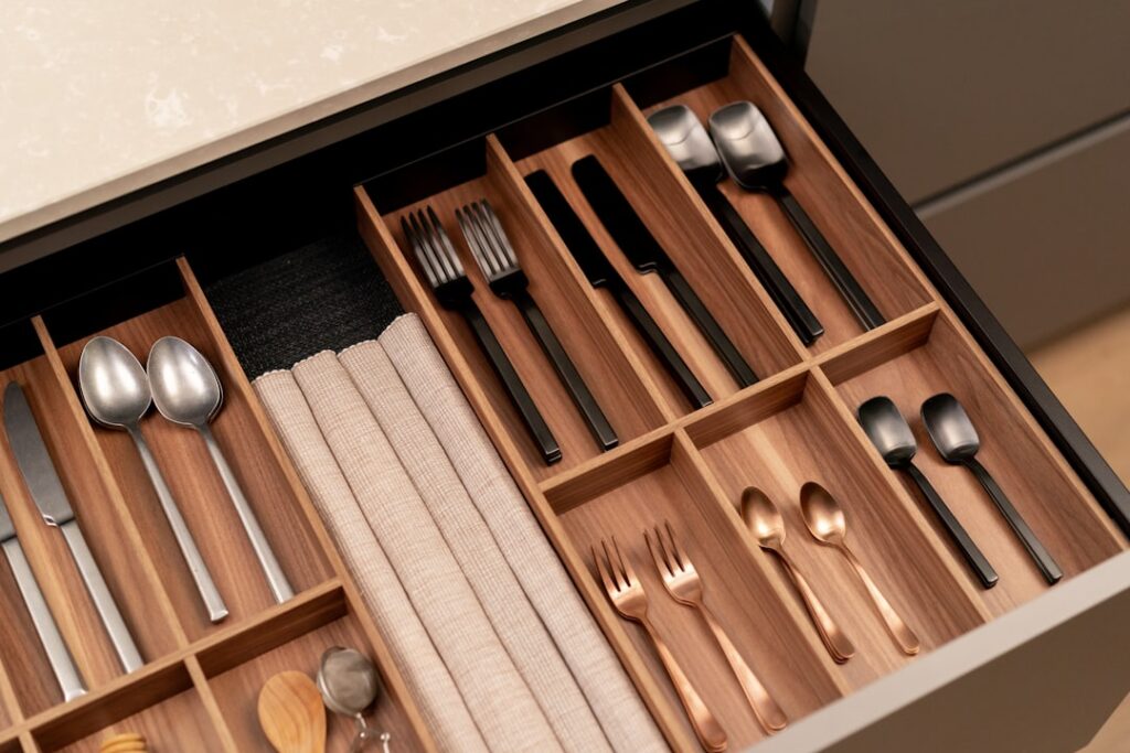 Neatly organized kitchen drawer with bamboo dividers separating utensils and tools
