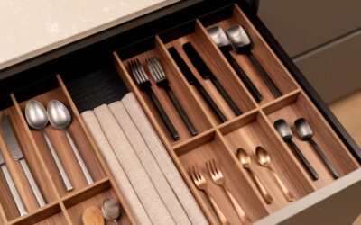 Neatly organized kitchen drawer with bamboo dividers separating utensils and tools