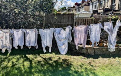 Stack of bright white freshly washed clothes neatly folded on a clean surface