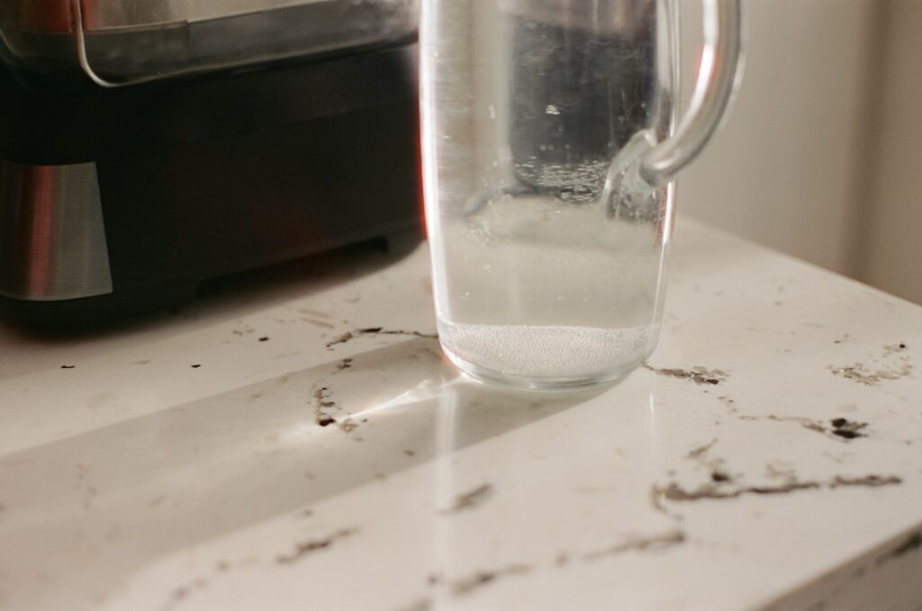 Close-up of water droplets on laminate flooring surface showing water resistance