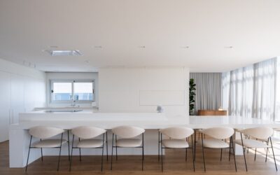 A spacious modern kitchen with an island layout and hardwood flooring