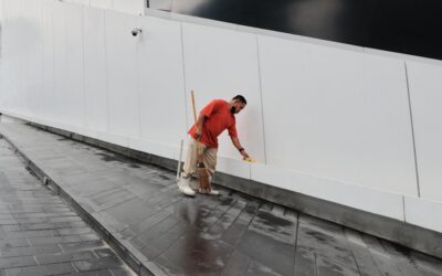 Professional installing laminate flooring planks in a home