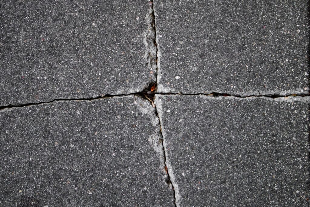 Close-up of a laminate floor repair being performed with a wax filler stick