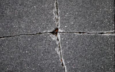 Close-up of a laminate floor repair being performed with a wax filler stick