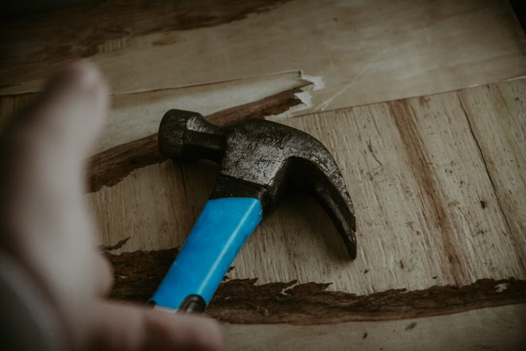 Essential laminate flooring installation tools laid out on a workbench