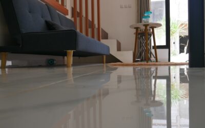 Waterproof laminate flooring installed in a kitchen with water droplets on the surface