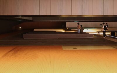 Person installing click-lock luxury vinyl plank flooring with a tapping block