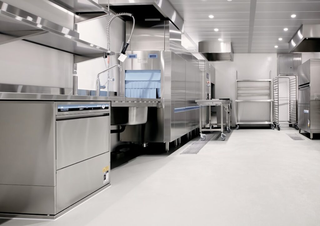 Glossy metallic epoxy floor with swirling silver and blue patterns in a modern room