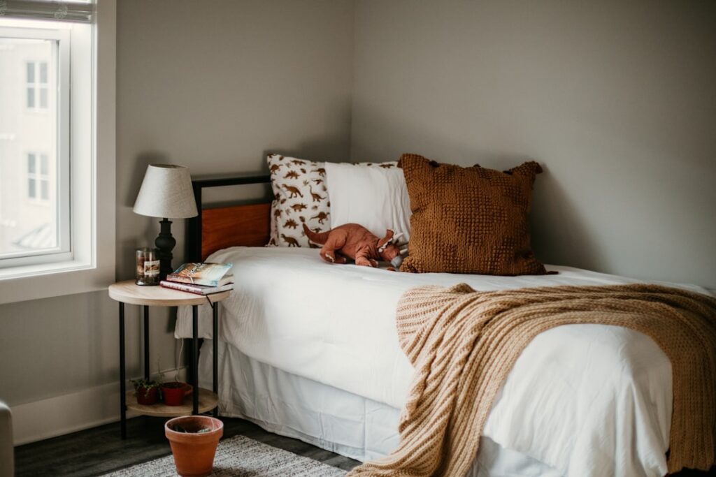 A stylish mid century modern bedroom with a walnut platform bed teak nightstands and warm lighting