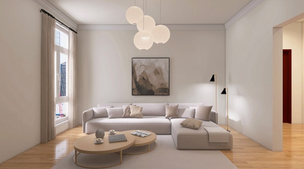 Bright minimalist living room with white walls, low-profile sofa, and light wood flooring