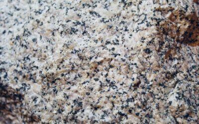 Kitchen island with polished natural stone countertop showing dramatic veining