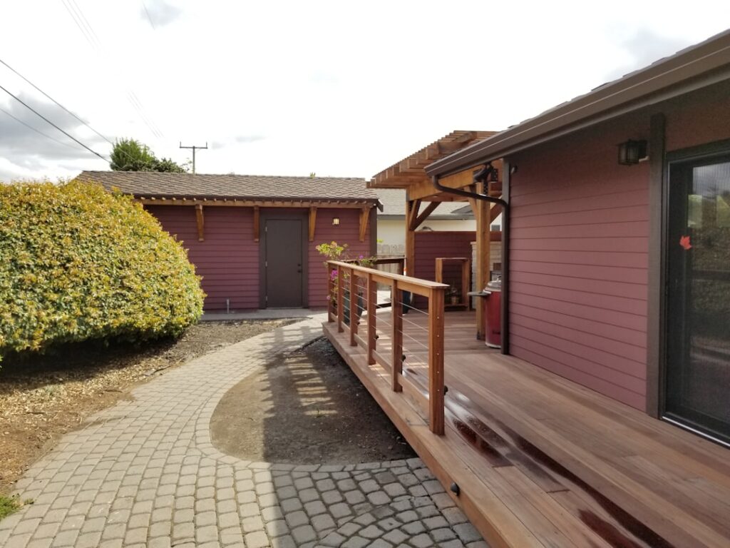Beautiful outdoor patio with natural stone flooring surrounded by landscaping