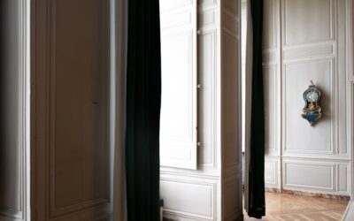 Full-length over the door mirror hanging on a white bedroom door