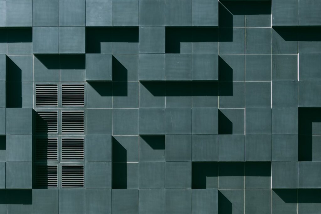 Peel-and-stick carpet tiles being installed on a clean floor