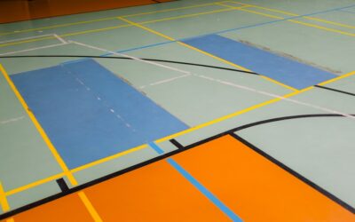 Black rubber gym mats installed in a home gym
