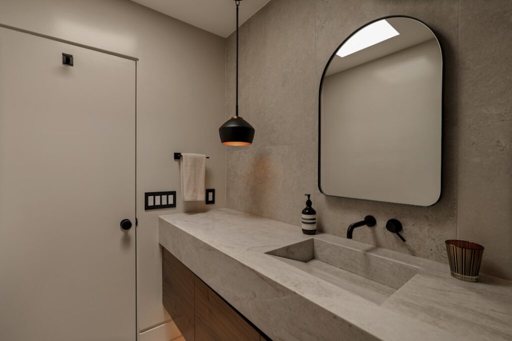 A clean modern shower insert with built-in shelves installed in a renovated bathroom