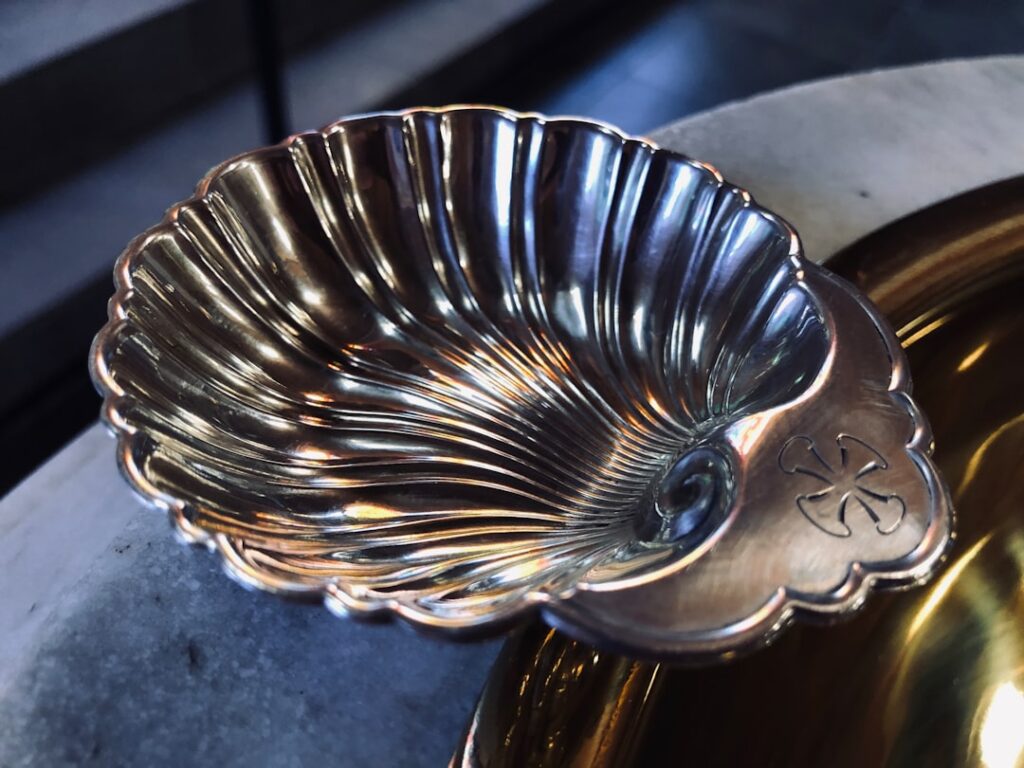 Hand polishing tarnished silver flatware with a cleaning cloth