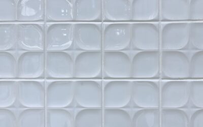 White subway tile backsplash behind a kitchen countertop with open shelving