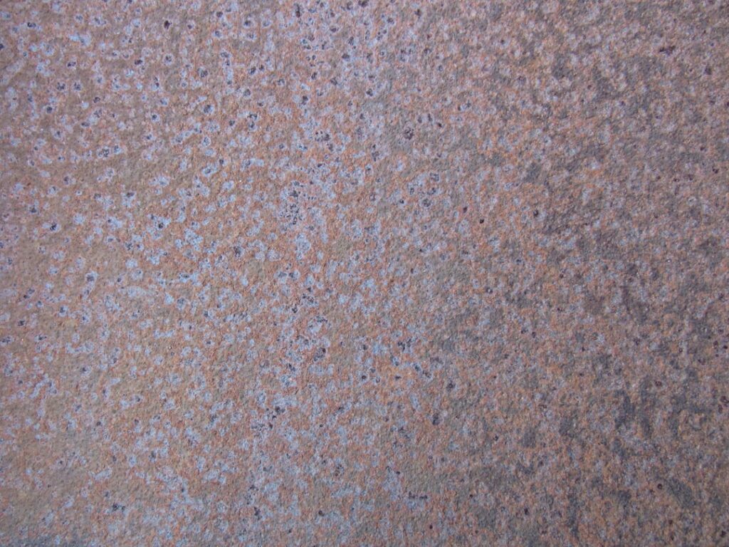 Multiple types of laminate flooring samples showing different finishes and textures