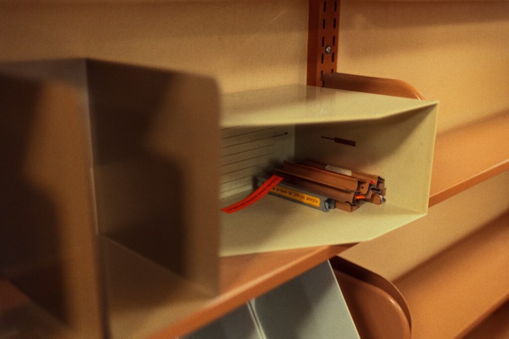 Neatly organized under-sink cabinet with pull-out drawers and cleaning supplies